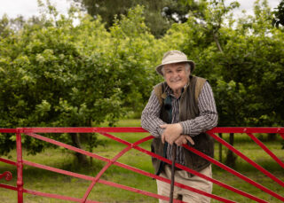 Leaning on the orchard gate